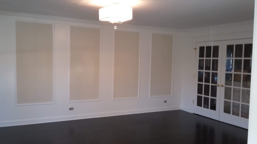 Elegant dining room with painted raised wall paneling