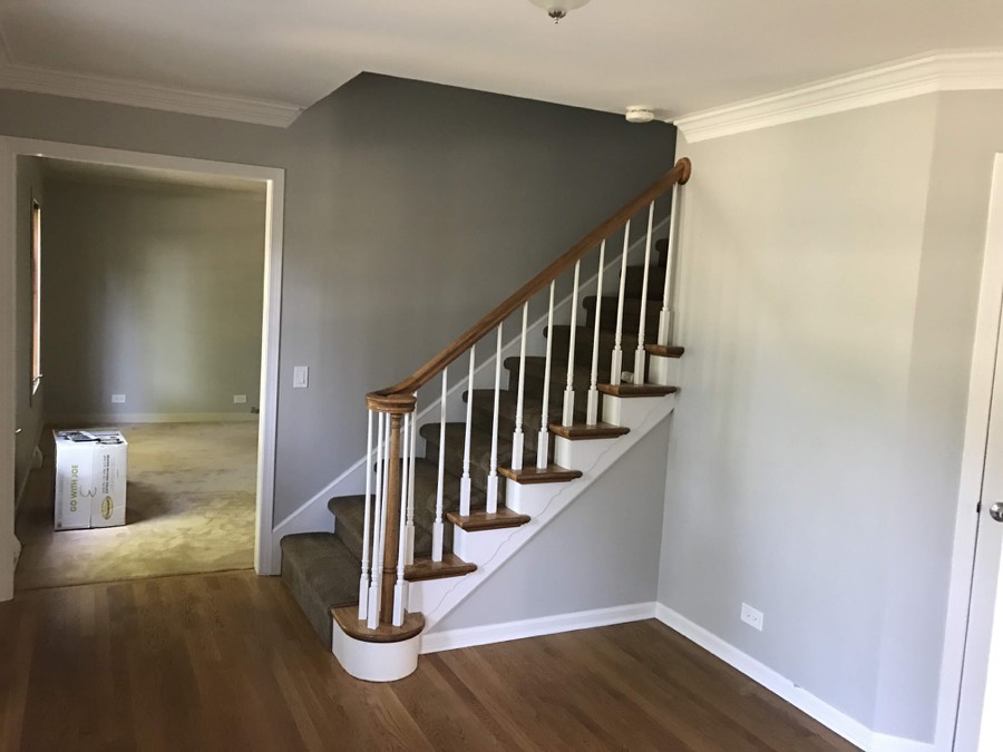 Repainted stairway and hallway with wood banister
